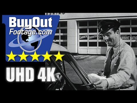 USA 1950s: Gas Station Attendant Fills Gas Tank, Washes Windshield