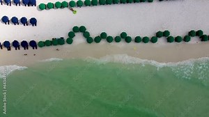 Destin Miami Florida Beach service of Resort hotel on the beachfront with colorful umbrella and chairs. Troical vacation with sandy beach beachfront hotel chairs and umbrella beach service concept