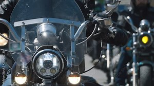 subculture biker group ride on the track on a Sunny summer day on custom motorcycles, a large-scale action of motorcyclists