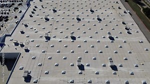 Full parking at entrance of large grocery store with commercial rooftop and packaged units RTU on flat roof, HVAC conditioning cooling, dehumidifying, heating, heat pump and air handlers, flyover