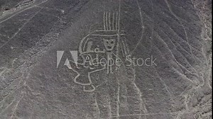 Close up view of single human figure and bird camera rising up to high POV of the Nazca Lines geoglyphs made in the soil of the Nazca Desert Aerial video