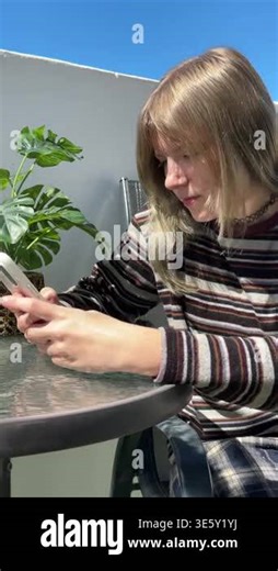 young woman using a smartphone at home Stock Video Footage - Alamy