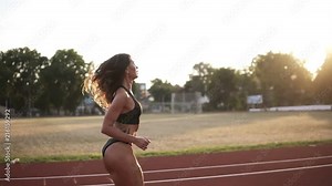 Slow motion of young beautiful female athlete launching off the start line in a race. Female runner started the sprint from the starting line
