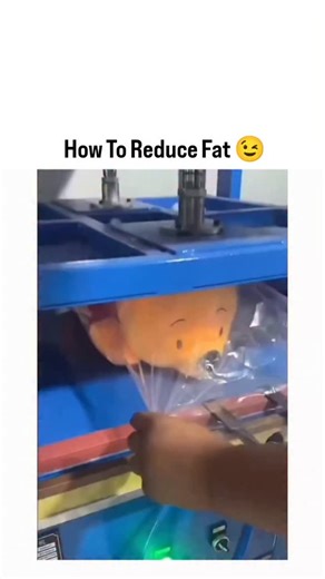 picpac19 on Instagram: "This roughly 29-second clip from a bustling Chinese stuffed toy factory showcases a hilariously cathartic manufacturing process where workers repeatedly flatten adorable yellow Winnie the Pooh plushies—complete with red shirts and cute stitched faces—using a large blue hydraulic press machine with glowing green lights and safety stickers, starting with a hand placing the fluffy toy on the colorful platform, activating the press to squish it into a pancake-like sheet amid 