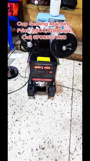 an automatic cup sealing machine. It is used to seal cups for beverages like bubble tea, juice, and coffee. The machine is fully automatic, which means it feeds, seals, and ejects the cups without manual intervention. It can seal 500-650 cups per hour and is compatible with cups that have a diameter of 90/95mm. The machine features a digital control panel with an LCD display for easy operation. It is made of durable materials like carbon steel and stainless steel. #KairumbaZEmpire #kairumbaaraal