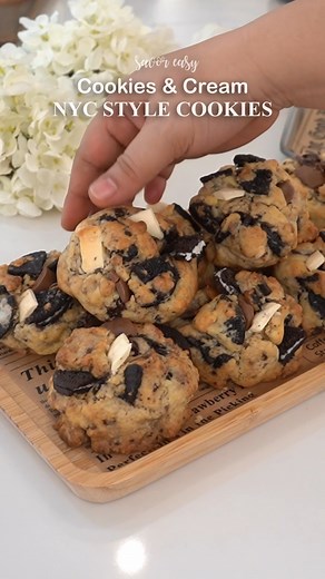 NYC Style Cookies & Cream Cookies Cookies & Cream Cookies are insanely yummy kind of cookie. Here's what you'll need: 1 cup butter (220g) unsalted (cold) 3/4 cup brown sugar (150g) 1/2 cup sugar (100g) 2 large eggs 1 tsp vanilla extract (5ml) i used clear vanilla extract in the video, you can use whatever is available for you :) 3 cups all purpose flour (375g) 1 tsp baking soda (4g) 1/2 tsp baking powder (2g) 1/2 tsp salt (3g) 1 cup chopped oreos (coarsely chopped) 1 cup chopped semi sweet choco