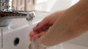 hand of beauty woman wash your hands at the wash basin with foam, cleanse the skin and have water flowing through the hands. Health and beauty concepts