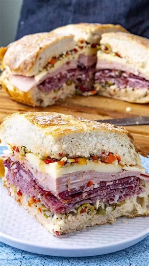 This muffaletta recipe is the ultimate sandwich from New Orleans, piled high with Italian meats, cheese, and a homemade spicy olive salad. Feeds a crowd! >> Comment “RECIPE" and I'll send this recipe straight to your DMs! 🥳 GET THE FULL RECIPE ⬇️ https://www.chilipeppermadness.com/recipes/muffaletta/ #sandwich #sandwiches #muffuletta #muffalettasandwich | Chili Pepper Madness - Big Flavor Recipes