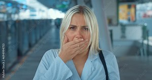 Shocked woman takes off glasses, covers mouth with hand. Expressive emotional stunned dazed appalled woman opens mouth in shock, covers in disgust, looks around in incomprehension and bewilderment