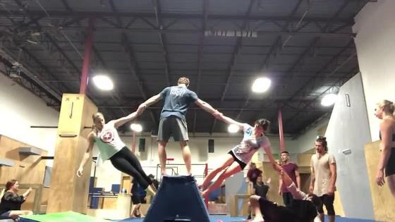 Group of People Hold Each Other's Hands to Perform Amazing Acrobatic Move
