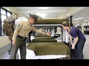 U.S. Marine tries to teach reporter how to make a military-style bed
