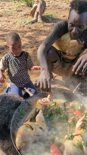 Traditional Hadzabe tribe cooking wild meat in Tanzania.Village food and African culture lifestyle.