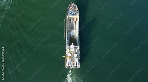 Sand dredging ship collect tons of sand and seawater for a coastal city replenishment project. Drone view