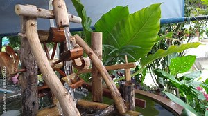 Wooden water wheels in pond. Small waterwheel spinning from the current garden. Rotates under sun water falls. cute artifact