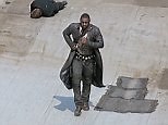 Idris Elba on rooftop with film crew shooting the Dark Tower