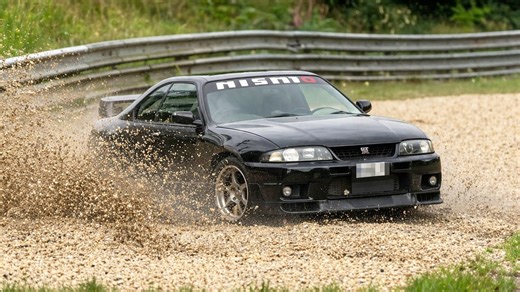 Skyline kicks up gravel near Nürburgring barrier