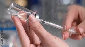 medicine, female hand draws syringe for injections from a bottle, close-up