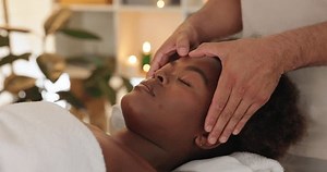 Spa, hands and black woman with face massage for relax, skincare or beauty with dermatology routine. Health, calm and masseuse with African female person for facial treatment at luxury holiday resort