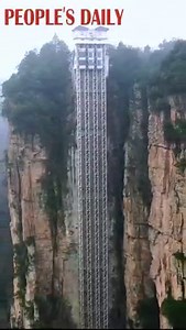 This towering cliffside elevator in Wulingyuan scenic spot in central China's Hunan Province saves your efforts but costs your courage in mountain climbing. | People's Daily, China