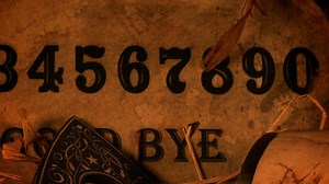 Ouija board game with a skull and candles - Free Stock Video