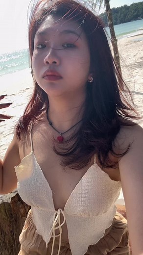 Beach Day Fun: Young Woman Enjoys the Sun and Sea