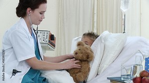 Female doctor examining a little patient