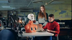 Cyborg's head is moving its mouth and tongue under control of two experts