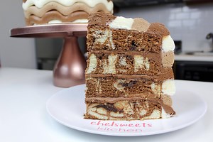 I shared my tutorial on how to make my marble layer cake recipe a few weeks ago, and I decided to share what did with those layers!! The cake layers were so delicious and moist, I knew they deserved an amazing buttercream!! I chose to fill the cake with my chocolate American buttercream, and decorate the cake with an easy buttercream pattern! In my mind, it's kind of what I picture when I think about a "ripple" cake. I wanted the ripples of chocolate that run through the layers to be present in 