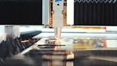 Robotic automated fiber laser cutter moves precisely across a metal...