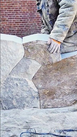 Stonemasonry in Progress: Cutting and Placing Large Natural Stone Slabs