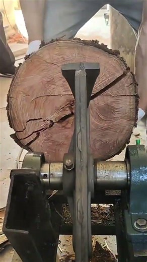 splitting large wood log using automatic hydraulic splitter machine for wood fuel requirements