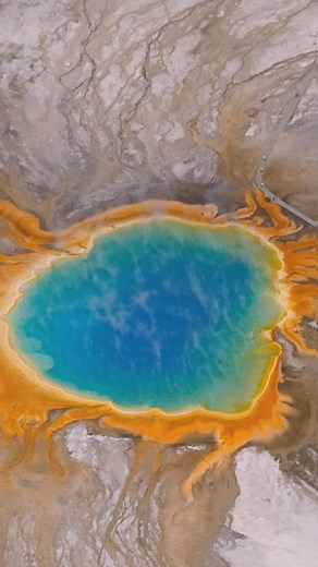 Atlas Obscura on Instagram: "Yellowstone’s Grand Prismatic Spring is a massive, burning-hot lake known for its vivid rainbow coloring, caused by a unique mix of geologic reactions at the site.⁠ ⁠ But for all its beauty, it also spews hundreds of gallons of scalding liquid every minute.⁠ ⁠ Observers are kept to a designated boardwalk that keeps them safe from the water (and keeps the environment safe from humans).⁠ ⁠ A rare few, however, have witnessed the Grand Prismatic Spring by boat. Life pre