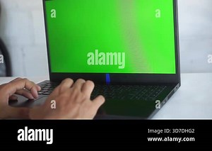 Worker scrolling touchpad green screen laptop at office workplace close up.