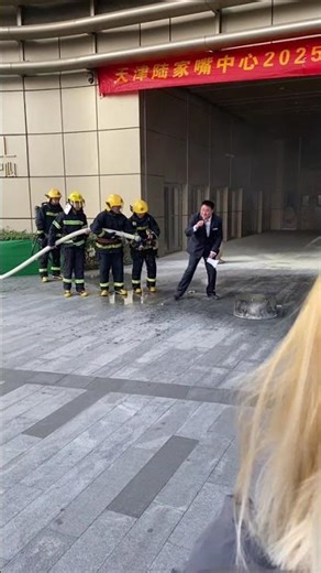 Announcer accidentally soaked during firefighting demo in Tianjin, China