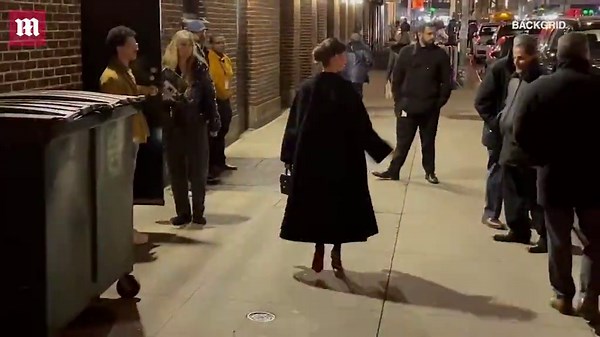 Lily Collins dons all black outfit with high heels and a two beaded necklaces