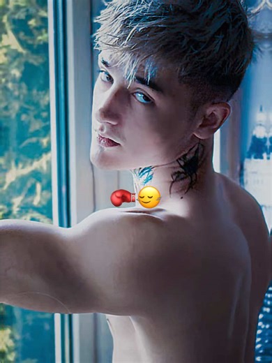 Shirtless Boxer Prepares for a Punch Near the Window