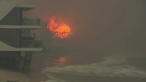 Wildfires burn out of control across Los Angeles area and kill 5 as thousands flee homes