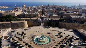 Aerial drone view of Valletta - capital of Malta island Europe, Mediterranean sea main church, dome, view of the Triton Fountain in the city center