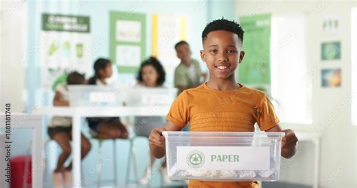 African American children sorting in recycling lesson with boy in orange holding bin labeled PAPER