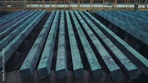 Ready-made steel billets are moving on a manufacturing line at an iron factory