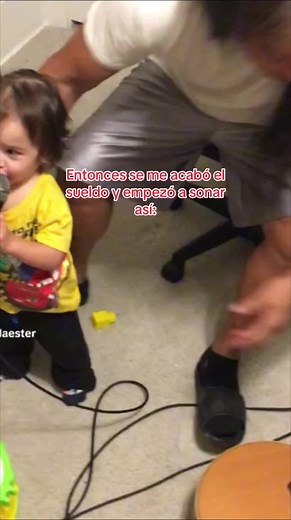 Toddler Singing and Playing Guitar in Adorable Scene