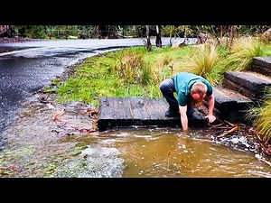 Unclogging a Blocked Culvert Flooding Over the Road