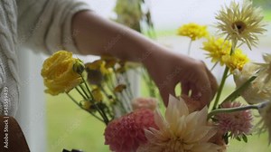 Detail view woman florist hands with garden scissor adjusts wonderful bouquet cutting fresh flowers stem and arrange, the process of making bridal decoration