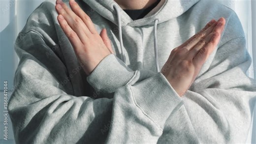 Arm-crossing gesture. Refusal and rejection. A person makes a gesture of refusal and rejection with their hands.