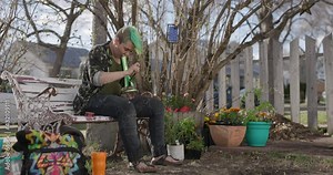 girl taking a bong rip outside in nature