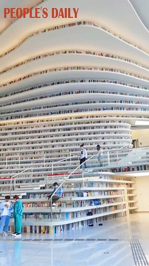 29K views · 942 reactions | Tianjin Binhai New Area Library, which features cascading ceiling-to-floor bookcases and terraced shelves, has become a cultural landmark and tourist destination in north China's #Tianjin. | People's Daily, China | Facebook