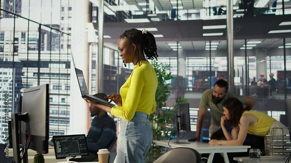 System administrator creating machine learning models that can process and analyze data to automate decision making processes. IT staff member using laptop to do programming in office, camera B