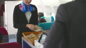 Air stewardess serving delicious food with tea for business travel,...