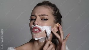 Woman shaving face. Funny young girl shaves her face like a man. Mustache, beard disposable razor. Stock Video
