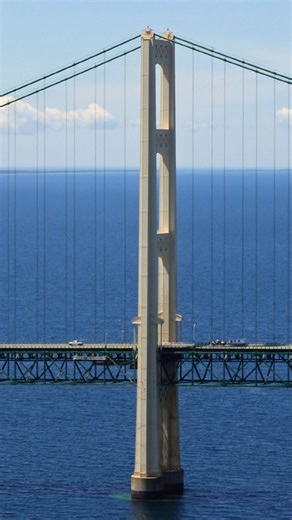 Why does the Mackinac Bridge have a steel truss underneath the road? The answer is more interesting than you think. #michigan #AMichiganThing #amichiganthing #mackinacbridge #mackinacbridge #mackinac #MichiganHistory #michiganhistory | A Michigan Thing